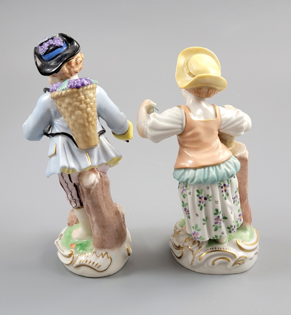 Pair of antique hand-painted Dresden porcelain figurines depicting a boy and girl gathering fruit on gilded Rococo scroll bases. View III