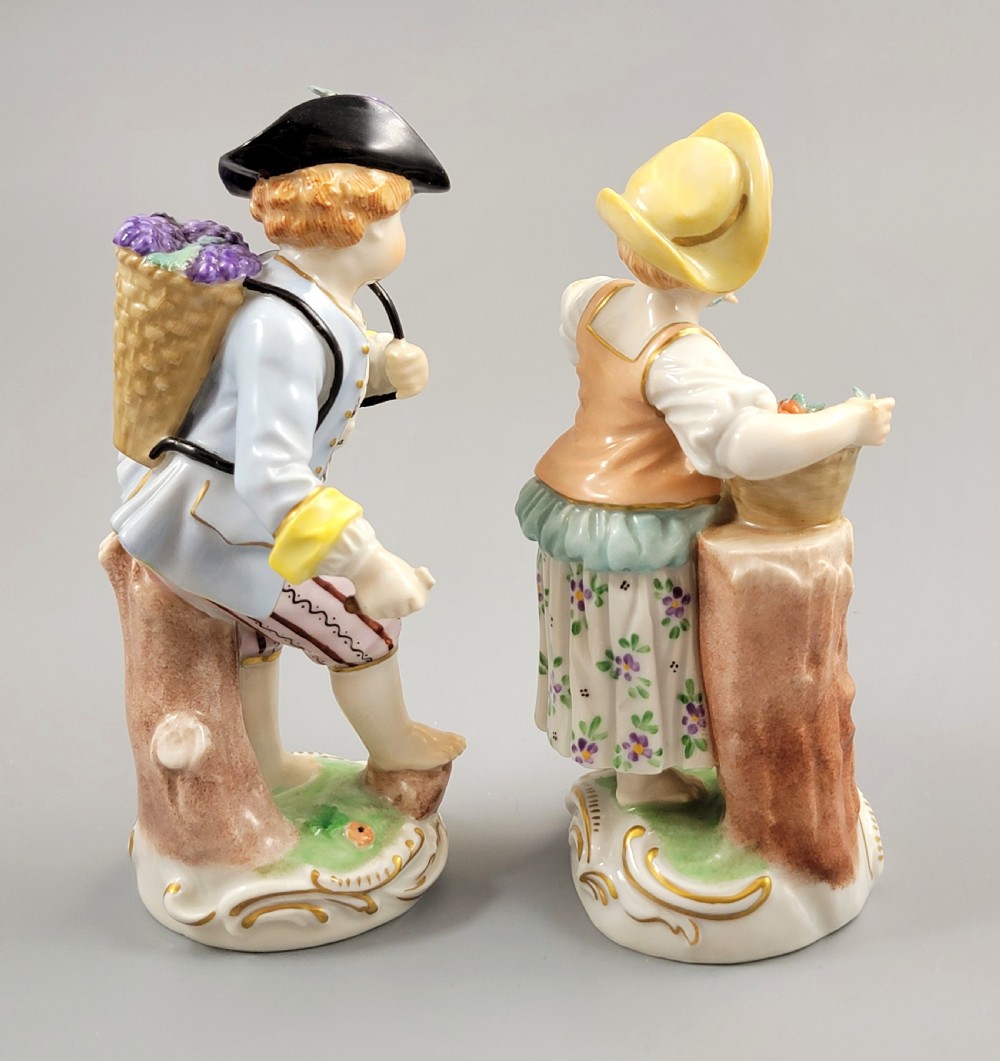 Pair of antique hand-painted Dresden porcelain figurines depicting a boy and girl gathering fruit on gilded Rococo scroll bases. View IV