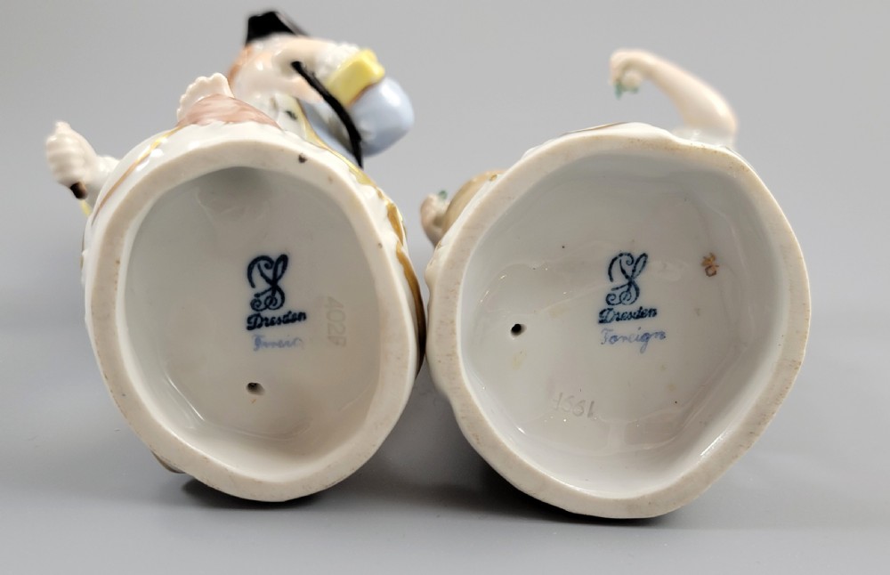 Pair of antique hand-painted Dresden porcelain figurines depicting a boy and girl gathering fruit on gilded Rococo scroll bases. View VI