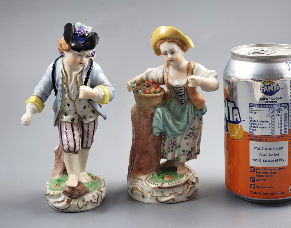 Pair of antique hand-painted Dresden porcelain figurines depicting a boy and girl gathering fruit on gilded Rococo scroll bases. View VII