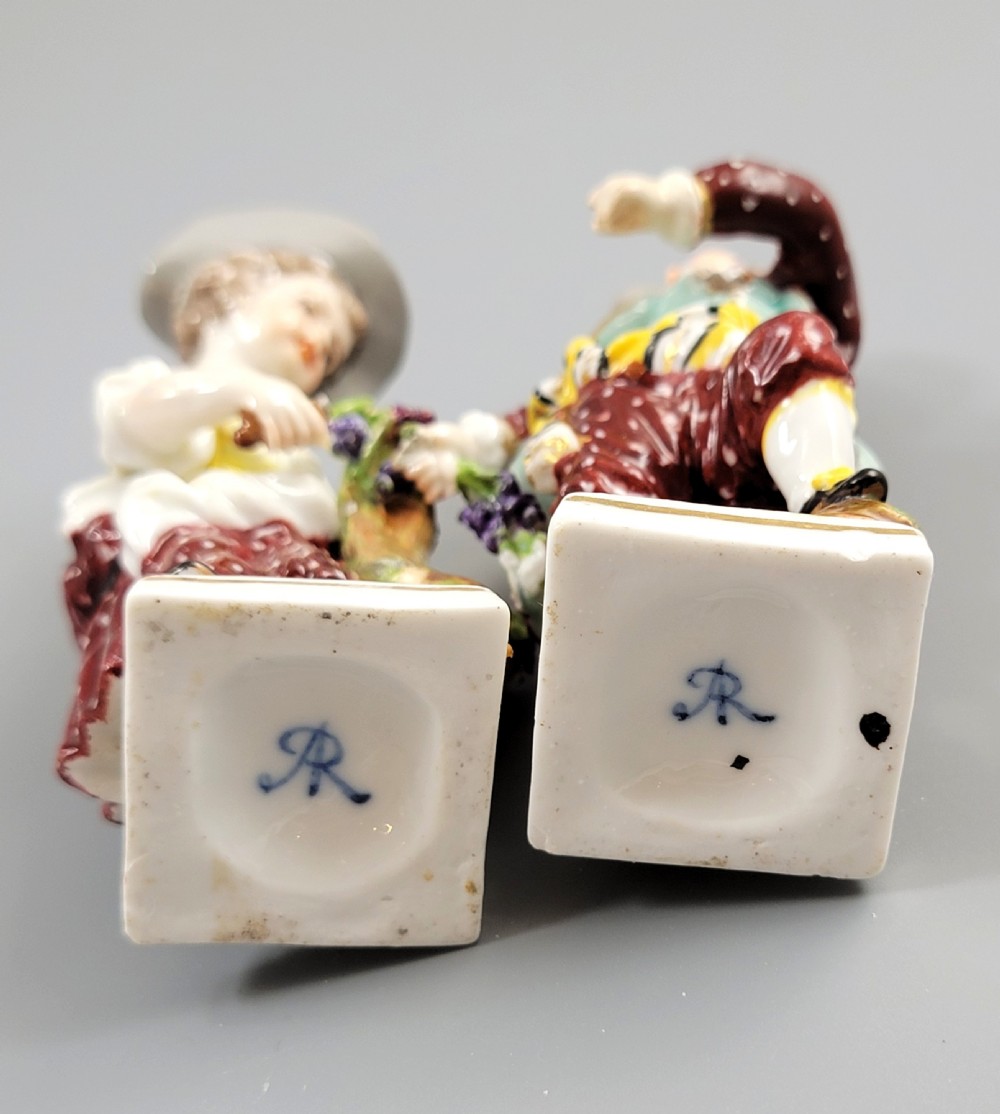 A pair of 19th-century Dresden porcelain figurines depicting a male and female grape picker in traditional attire holding baskets of purple grapes. View VII