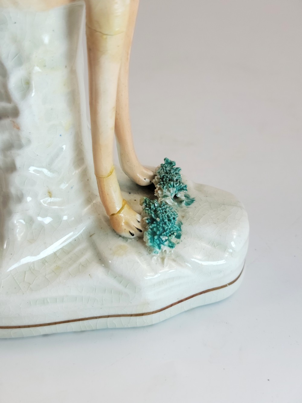 A pair of Victorian Staffordshire earthenware greyhound figurines standing on white bases with caught hares held in their mouths. View X