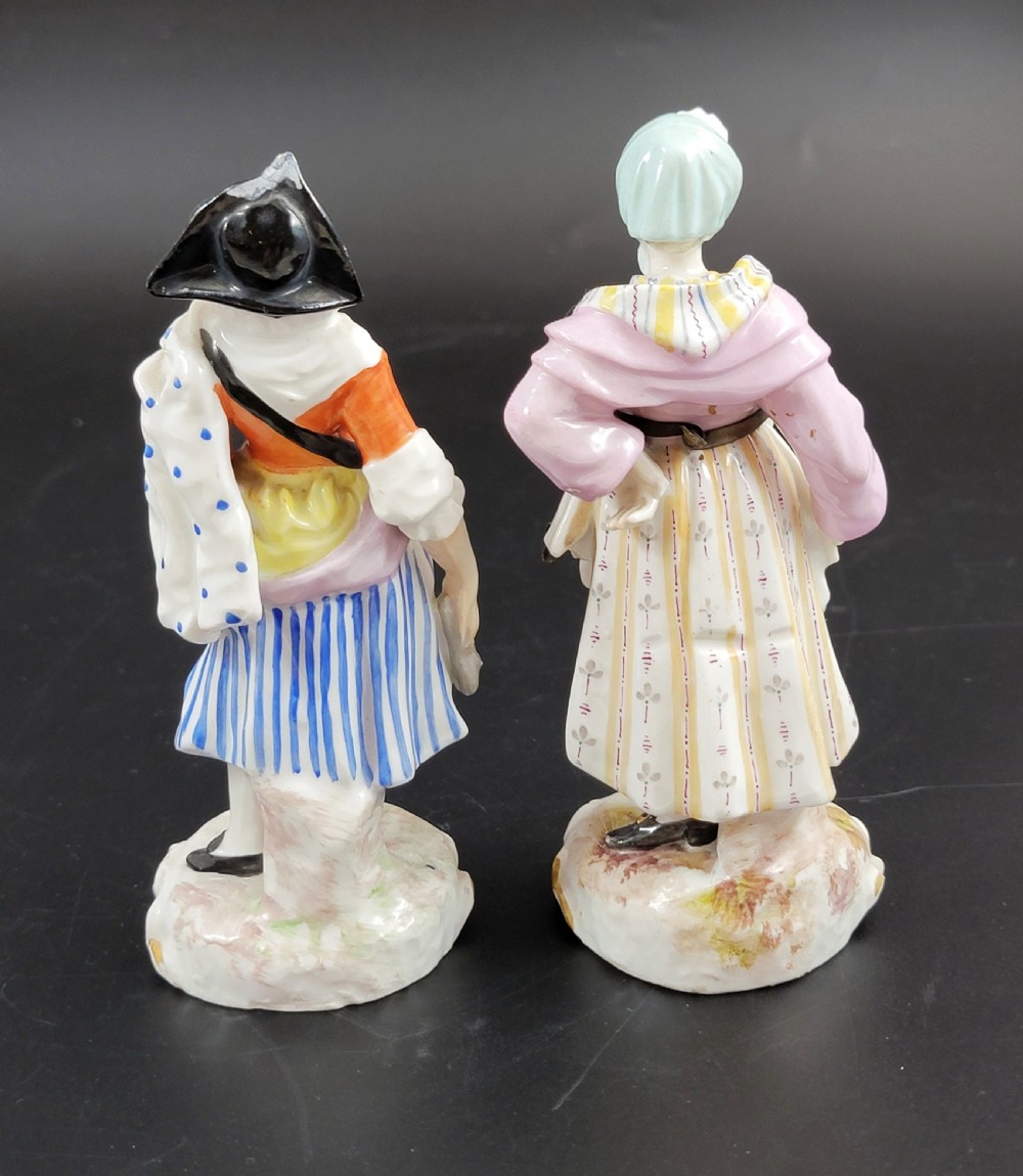 A pair of 19th-century Samson porcelain figures depicting street vendors in hand-painted colourful period dress standing on pierced scroll bases. View III