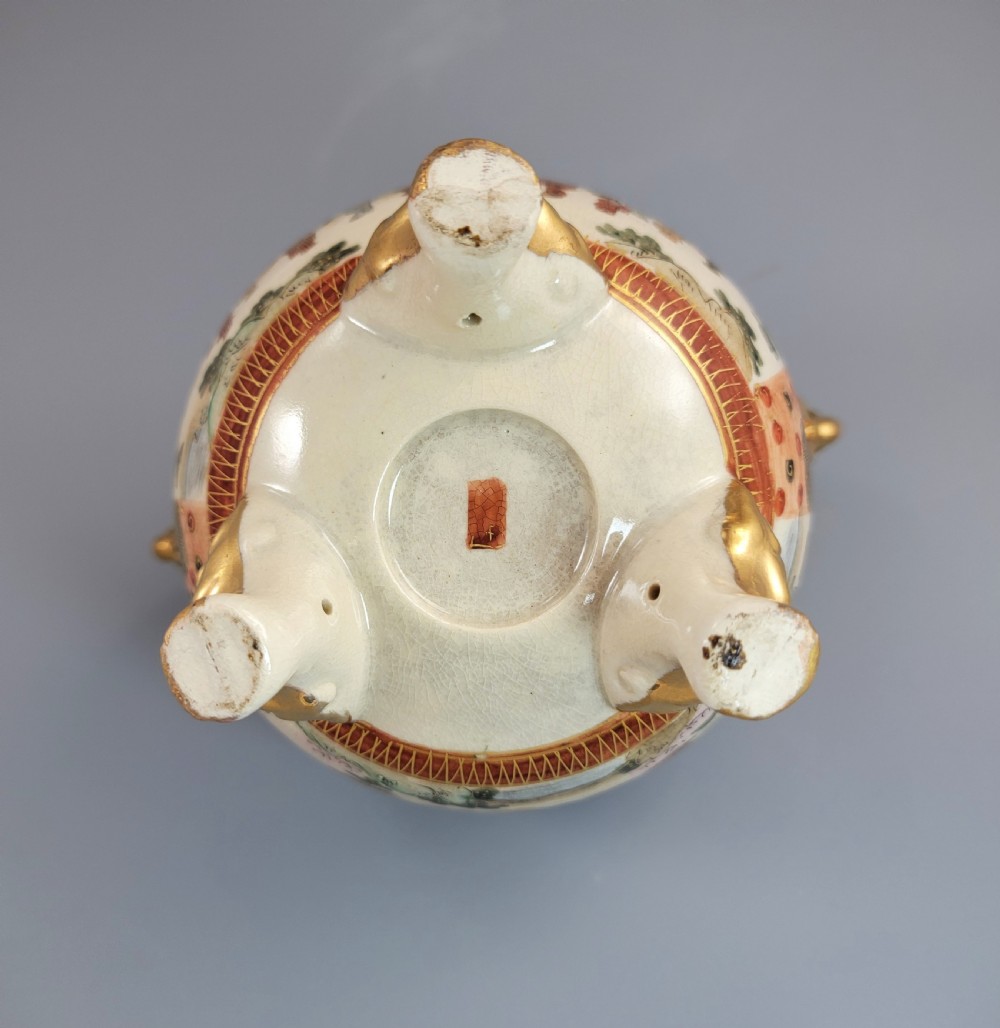 A Japanese Meiji period Satsuma earthenware incense burner featuring gilt shishi handles and finial with detailed hand-painted figures over a crackle glaze. View VIII