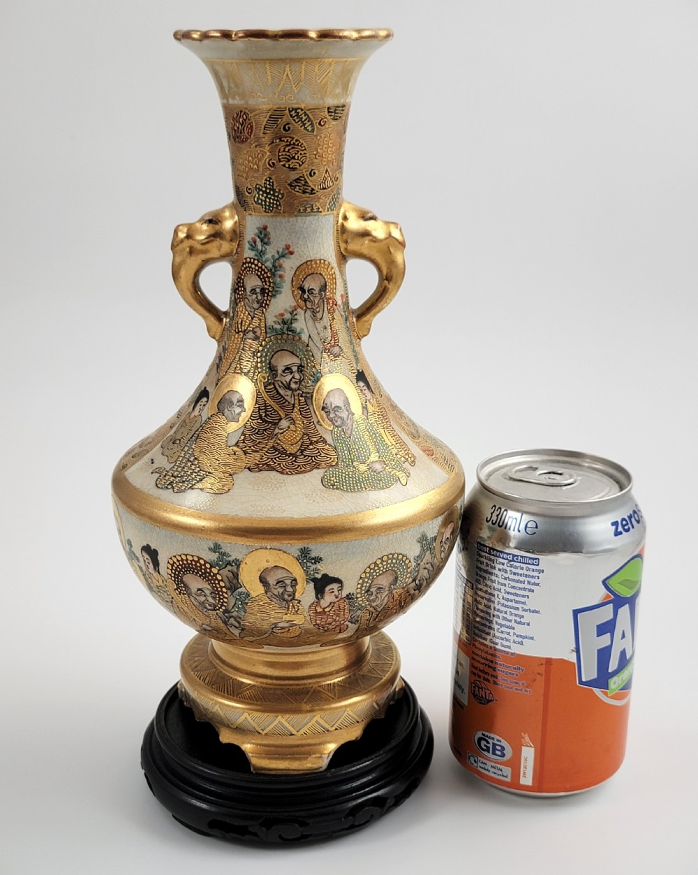An antique Japanese Satsuma earthenware vase featuring gilded elephant-head handles, hand-painted arhat figures, and intricate gold ornamentation. View XII