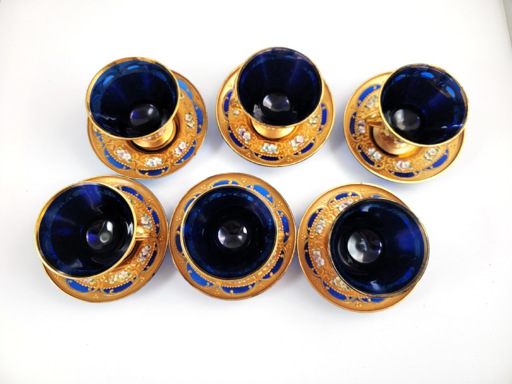 A set of six late nineteenth-century cobalt blue Bohemian glass tea cups and saucers featuring heavy gold gilding and raised enamel floral decoration. View III