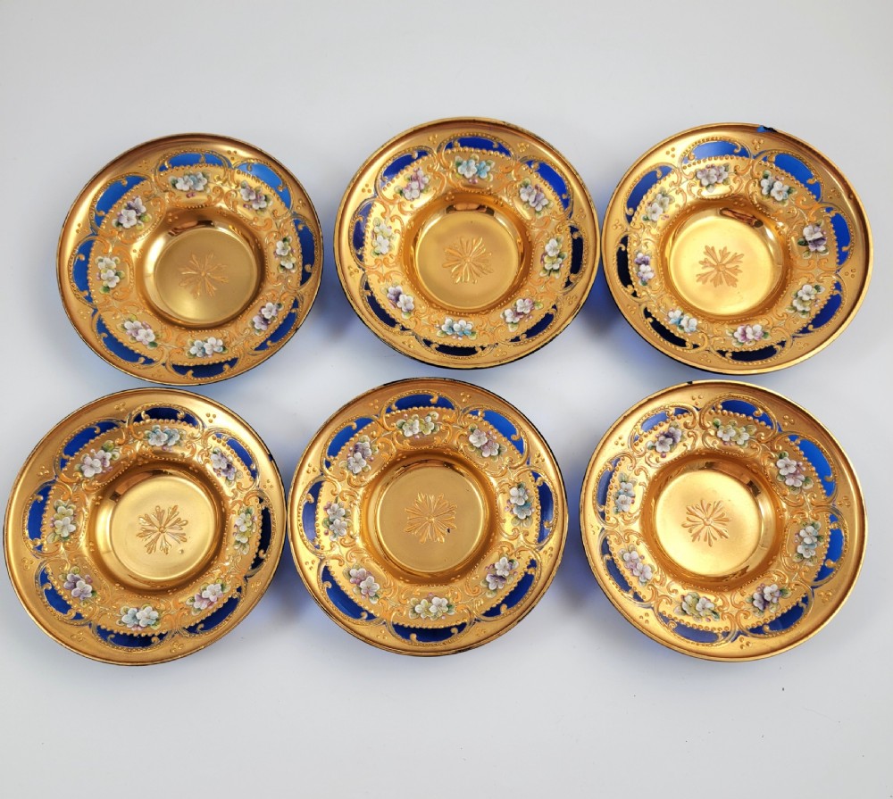 A set of six late nineteenth-century cobalt blue Bohemian glass tea cups and saucers featuring heavy gold gilding and raised enamel floral decoration. View IV