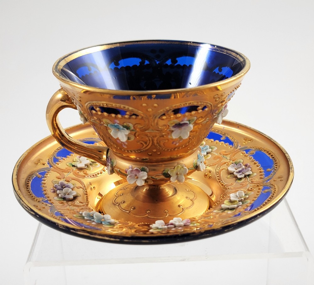 A set of six late nineteenth-century cobalt blue Bohemian glass tea cups and saucers featuring heavy gold gilding and raised enamel floral decoration. View XIII