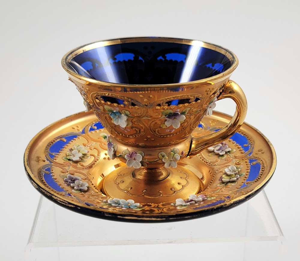 A set of six late nineteenth-century cobalt blue Bohemian glass tea cups and saucers featuring heavy gold gilding and raised enamel floral decoration. View XIV