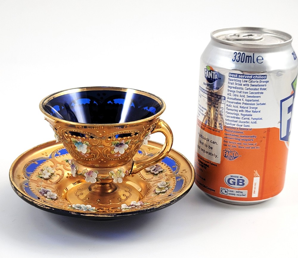 A set of six late nineteenth-century cobalt blue Bohemian glass tea cups and saucers featuring heavy gold gilding and raised enamel floral decoration. View XVI