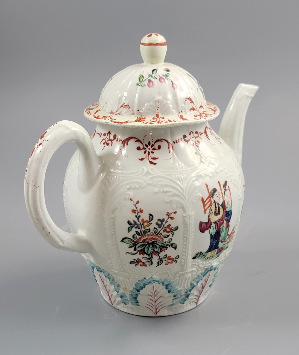 A Georgian soft-paste porcelain teapot decorated with hand-painted Chinoiserie figures, floral sprays, and moulded leaf work around the base. View III