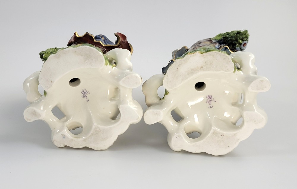 A pair of 19th-century French Samson porcelain figures depicting a male musician with a pipe and drum alongside a female musician holding a triangle, set on gilded rococo scrollwork bases. View VII