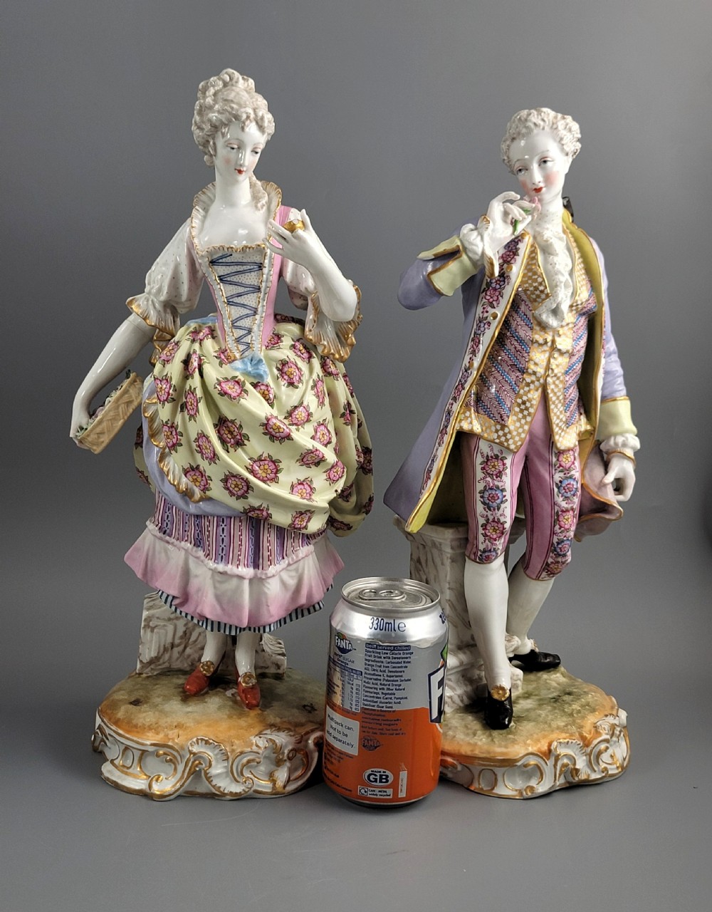 A pair of 18th-century German hard-paste porcelain figurines depicting a gentleman and lady in court dress on gilded bases. View VIII
