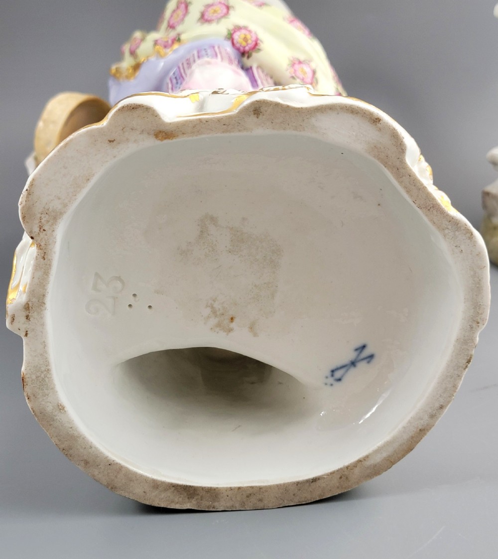 A pair of 18th-century German hard-paste porcelain figurines depicting a gentleman and lady in court dress on gilded bases. View IX