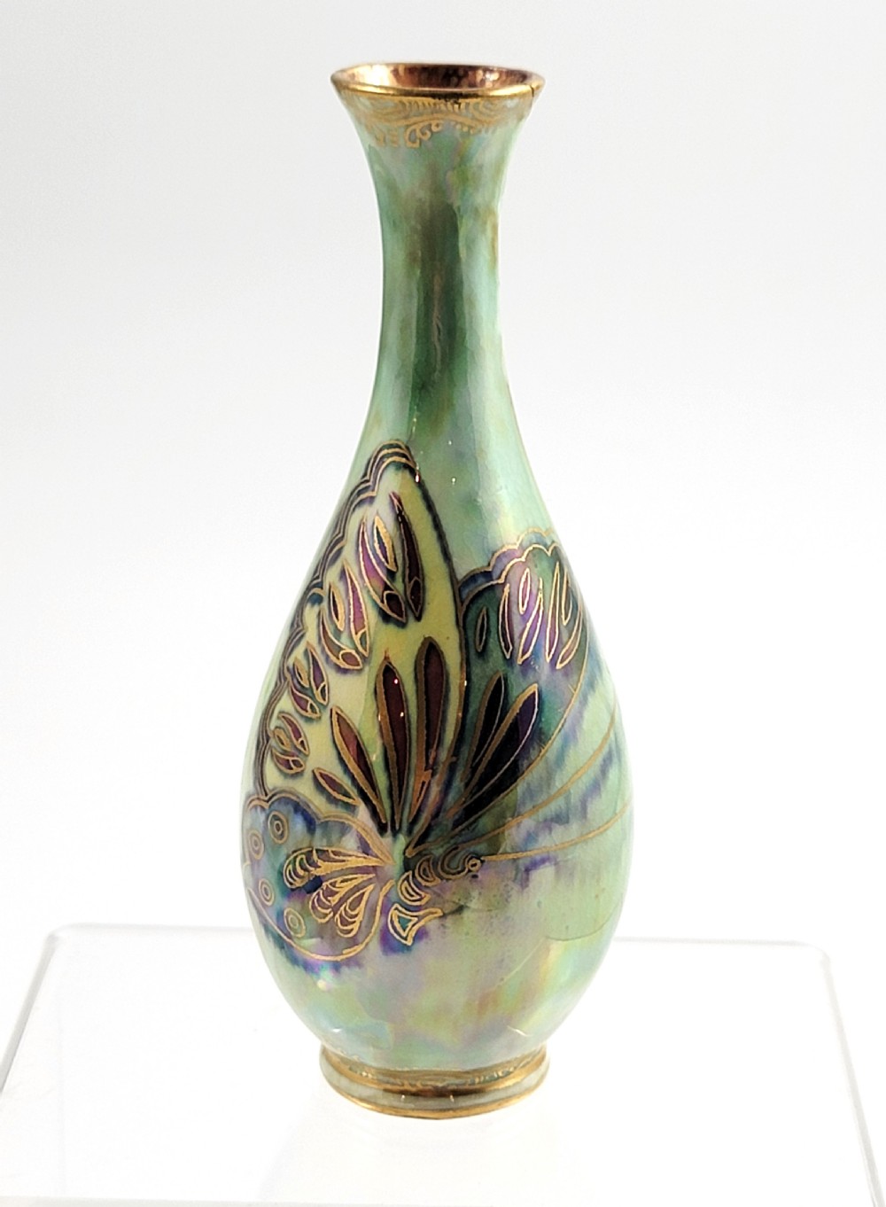 A slender, drop-shaped green lustre porcelain vase decorated with gilded butterfly motifs and iridescent purple highlights.