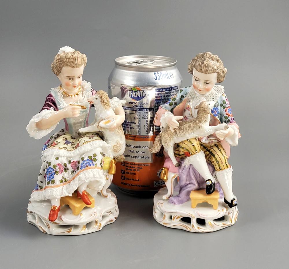 A pair of late 19th-century Sitzendorf porcelain figurines depicting a boy and girl in 18th-century clothing seated with pet lambs on gilded scrollwork bases. View VII