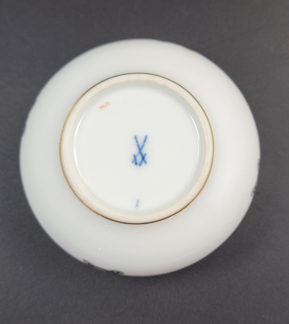 A circular white porcelain lidded trinket box adorned with a hand-painted grey dragon motif, red flame accents, and a gold gilt rim. View VII