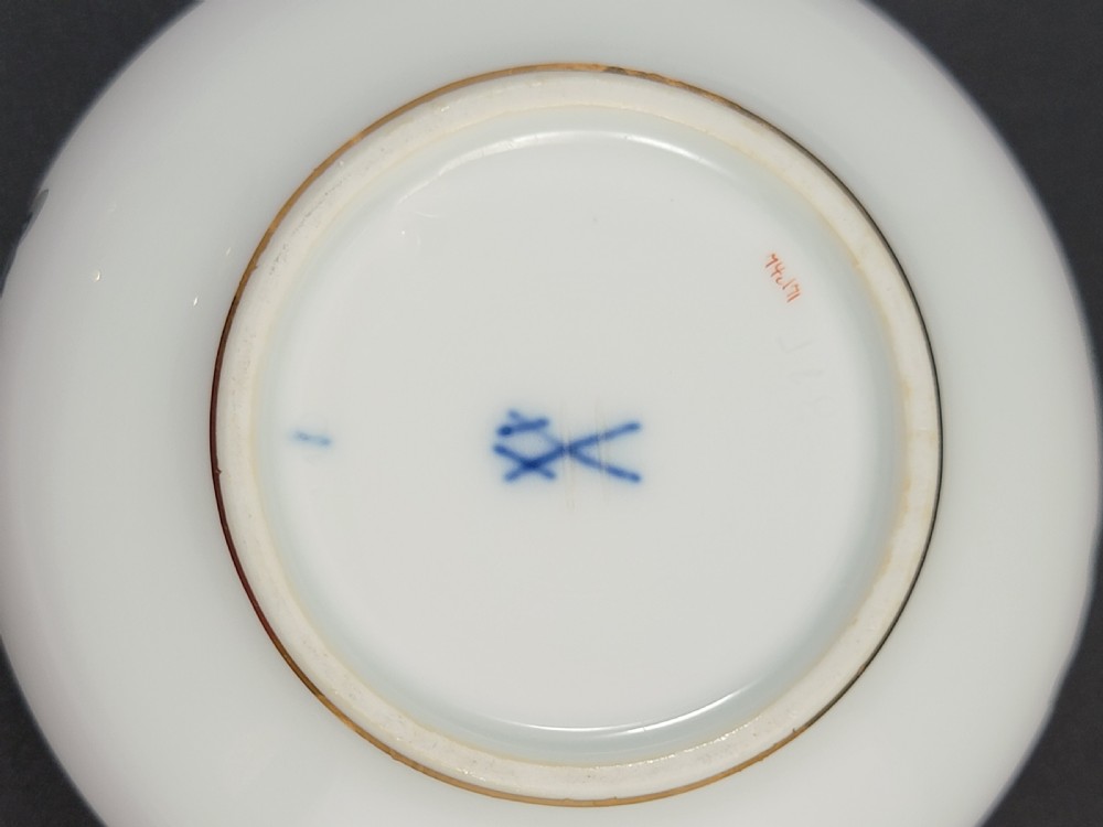 A circular white porcelain lidded trinket box adorned with a hand-painted grey dragon motif, red flame accents, and a gold gilt rim. View VIII
