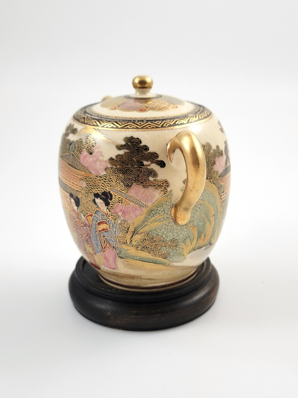 A lidded Japanese Satsuma ceramic sugar bowl with two gilt handles, crackle glaze, and hand-painted figures in a landscape. View II