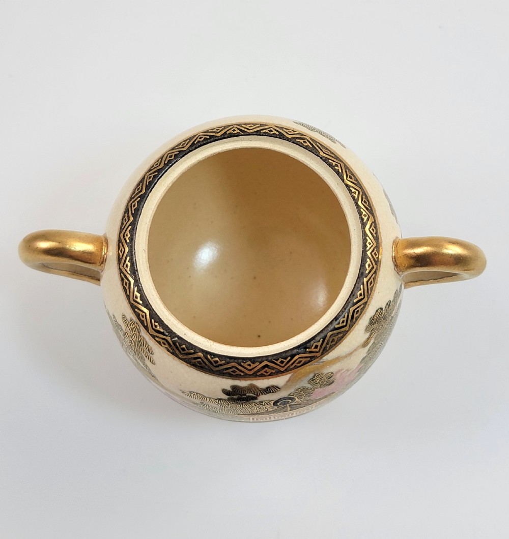 A lidded Japanese Satsuma ceramic sugar bowl with two gilt handles, crackle glaze, and hand-painted figures in a landscape. View VIII