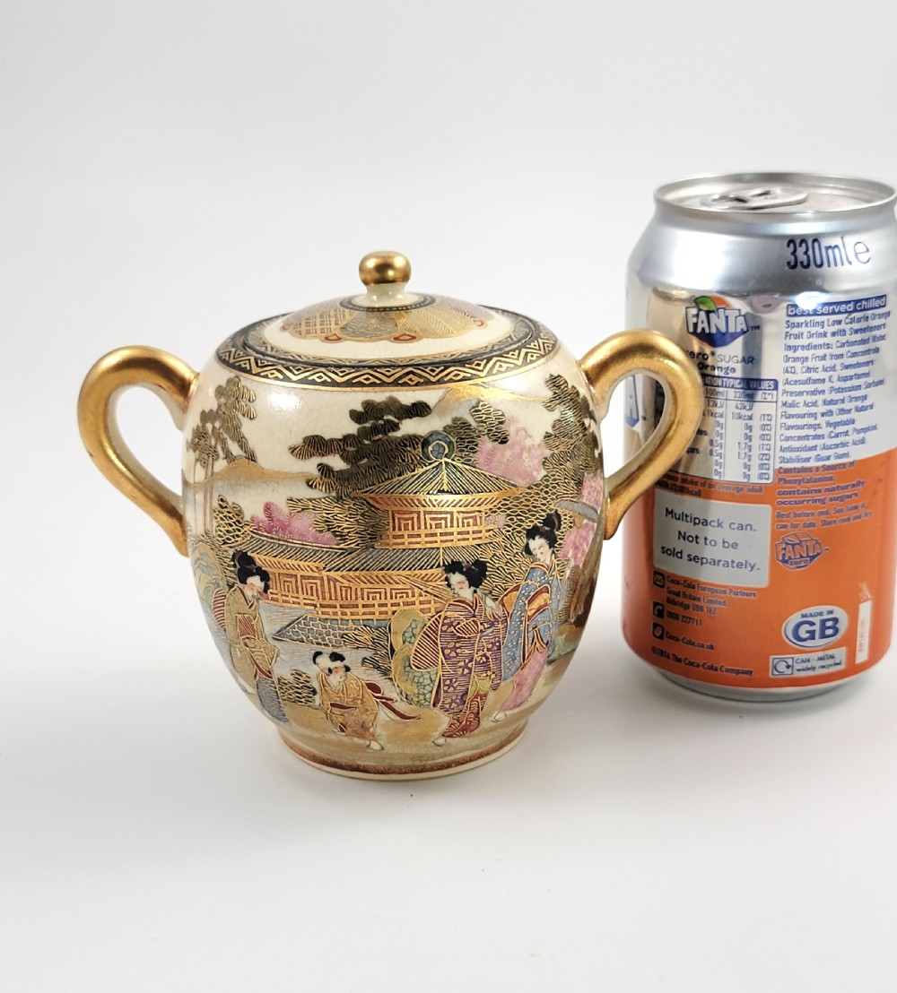 A lidded Japanese Satsuma ceramic sugar bowl with two gilt handles, crackle glaze, and hand-painted figures in a landscape. View XII