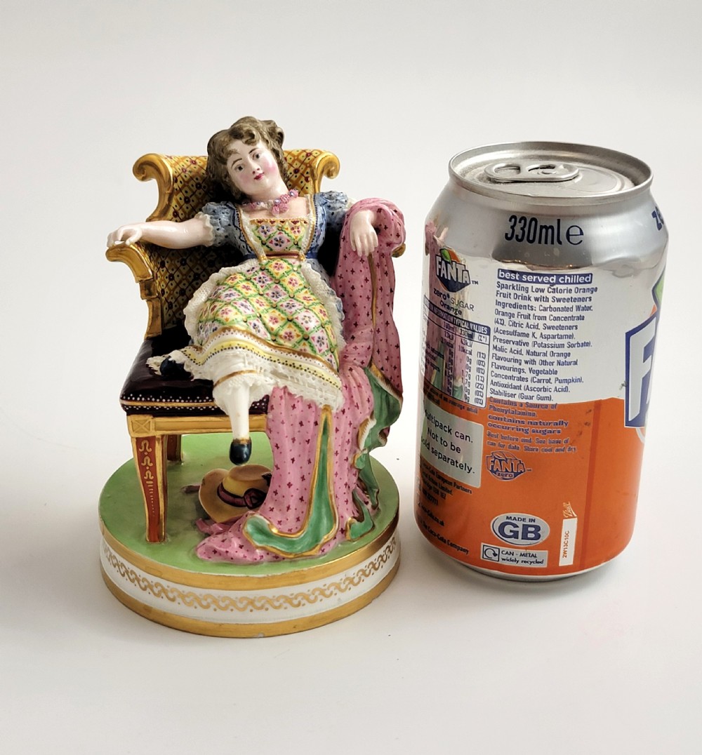 An 18th-century Derby soft-paste porcelain figurine depicting a seated woman in a colourful dress reclining on a gilded armchair. View VIII