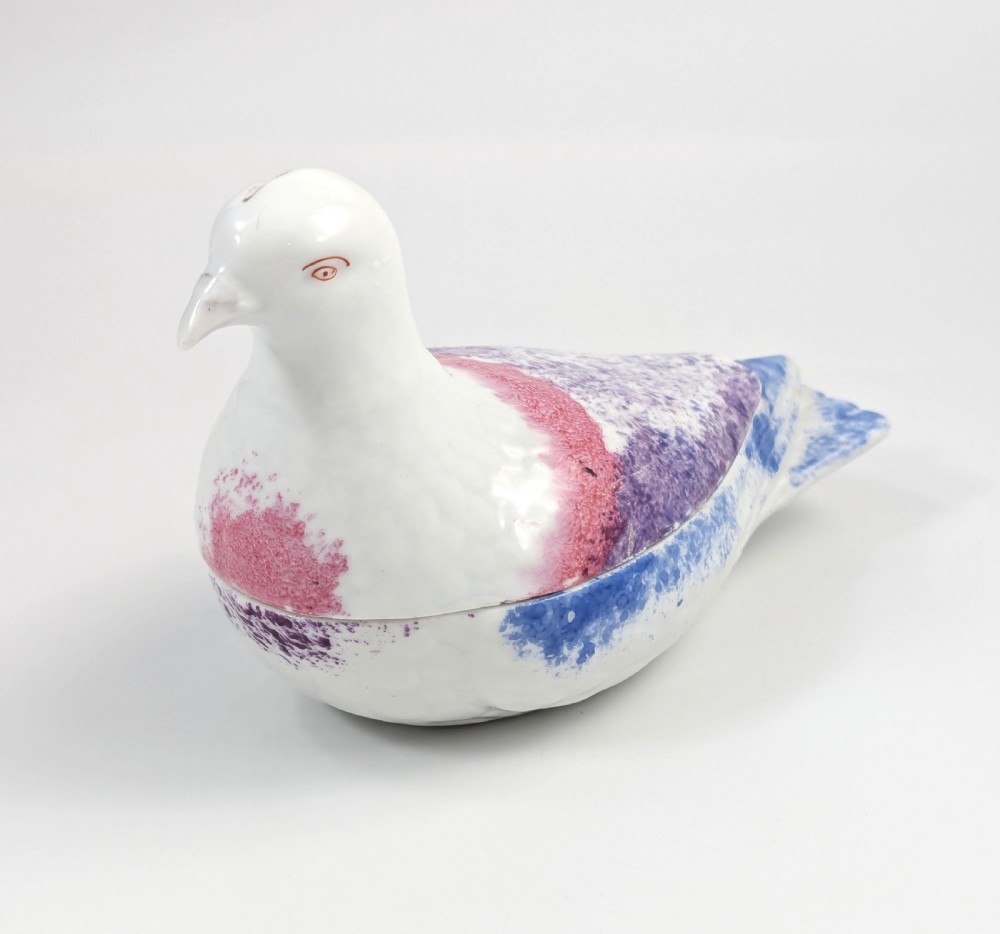 A late nineteenth-century Imperial Russian porcelain butter dish shaped as a seated bird with pink, purple, and blue stippled decoration.