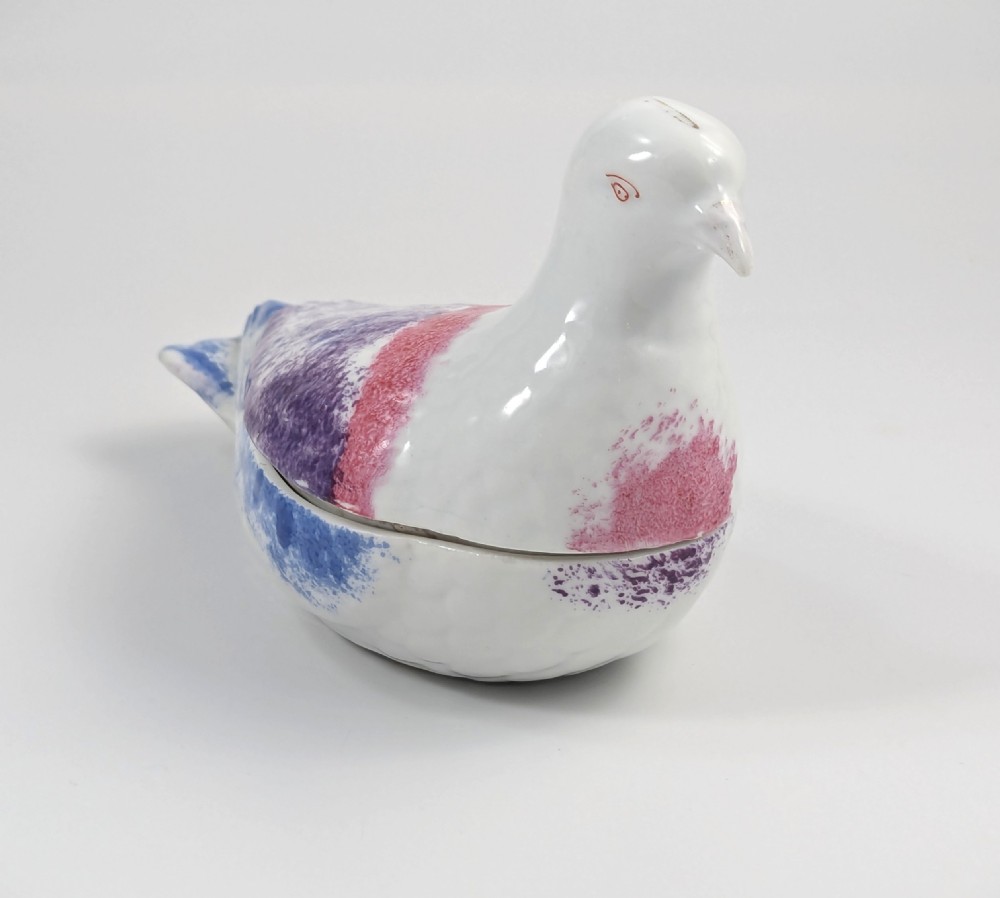A late nineteenth-century Imperial Russian porcelain butter dish shaped as a seated bird with pink, purple, and blue stippled decoration. View V