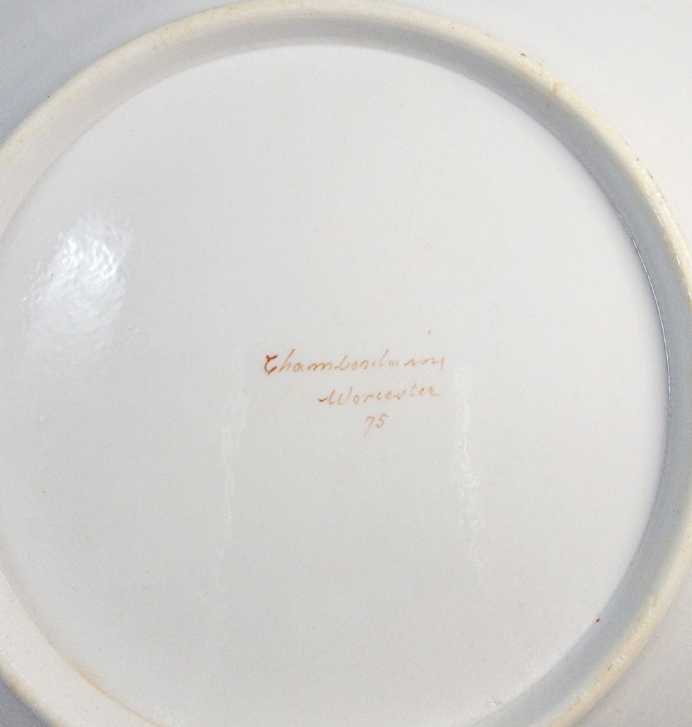 A circular antique English porcelain dessert plate decorated with hand-painted Chinoiserie panels, mythical dragons, and a pink central flower motif. View IX