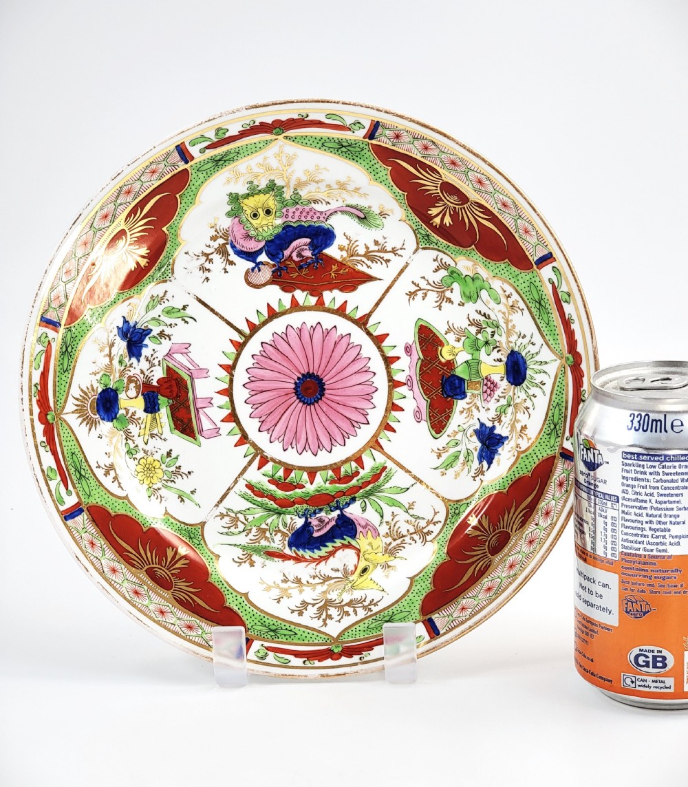 A circular antique English porcelain dessert plate decorated with hand-painted Chinoiserie panels, mythical dragons, and a pink central flower motif. View XI