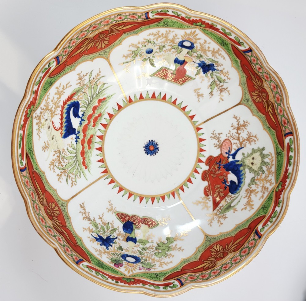 A Regency Chamberlain Worcester porcelain bowl with scalloped edges and colourful Chinoiserie enamel painting, resting on a carved dark mahogany stand. View XI