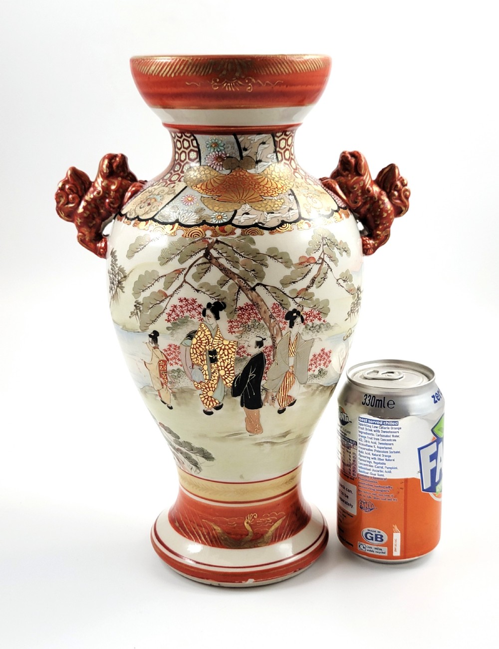 An antique Japanese Kutani porcelain vase featuring hand-painted figures, iron-red flared rim, gilded highlights, moulded lion handles, and a carved wooden display stand. View XIII