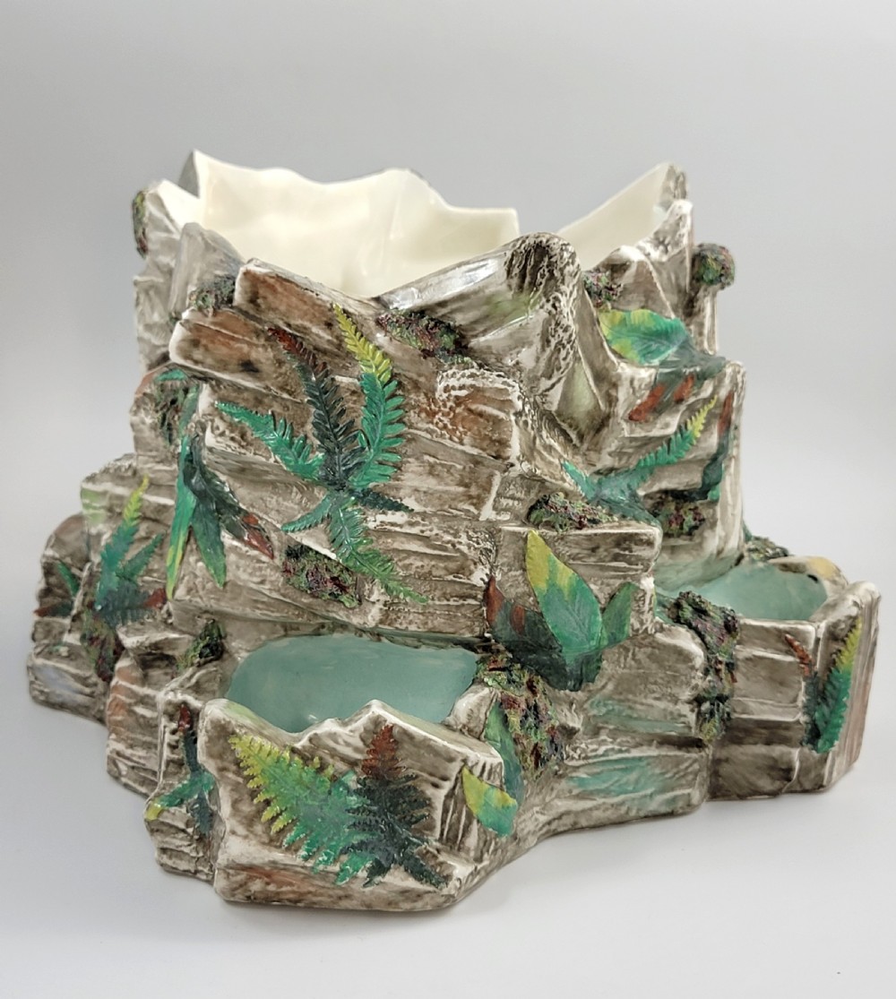 A Victorian Royal Worcester majolica ceramic jardiniere modelled as realistic rockwork with green fern fronds and moss detailing. View V