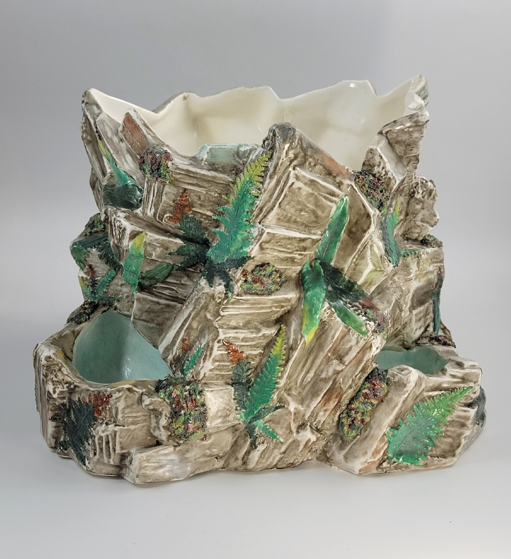 A Victorian Royal Worcester majolica ceramic jardiniere modelled as realistic rockwork with green fern fronds and moss detailing. View VII