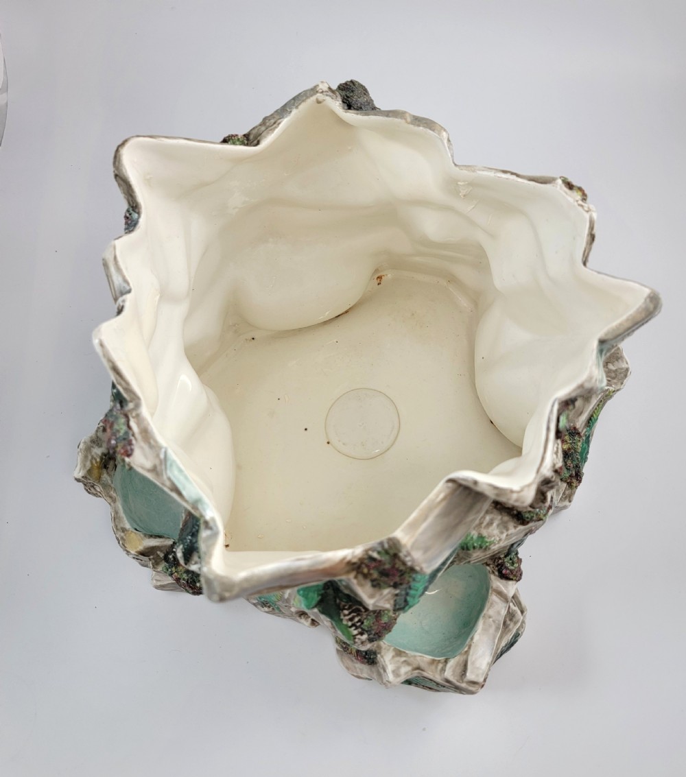 A Victorian Royal Worcester majolica ceramic jardiniere modelled as realistic rockwork with green fern fronds and moss detailing. View IX