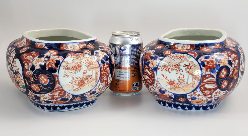 A pair of oval Japanese Imari porcelain jardinieres decorated with cobalt blue, iron red, and floral reserve panels. View VIII