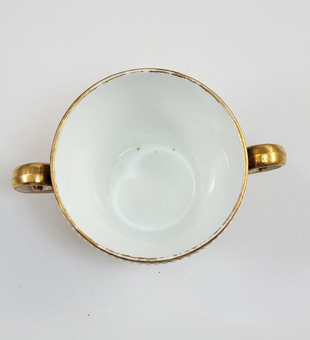 An antique porcelain chocolate cup and lid decorated with cobalt blue and gold Imari floral panels and raised white pearl borders. View VII