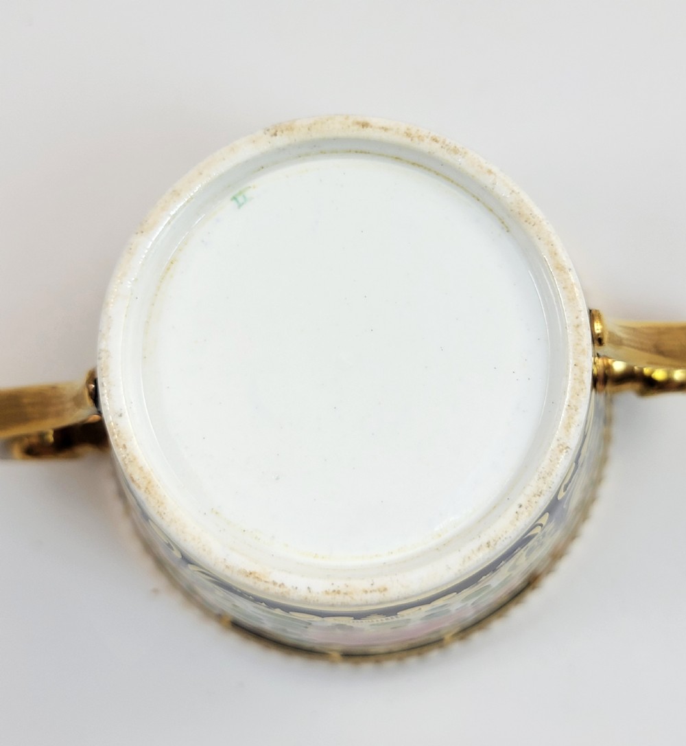 An antique porcelain chocolate cup and lid decorated with cobalt blue and gold Imari floral panels and raised white pearl borders. View VIII