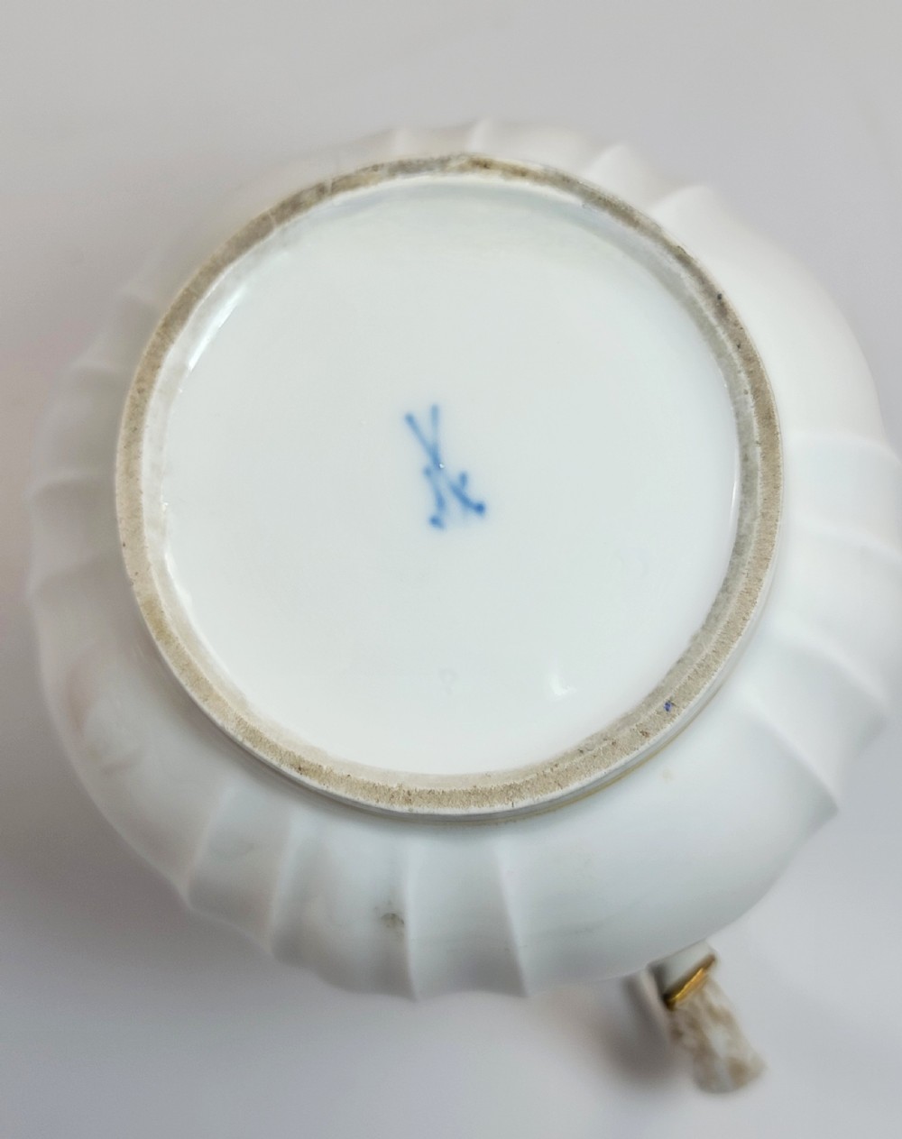 A white ribbed porcelain jug decorated with hand-painted birds, insects, and gilding along the spout and handle. View IX