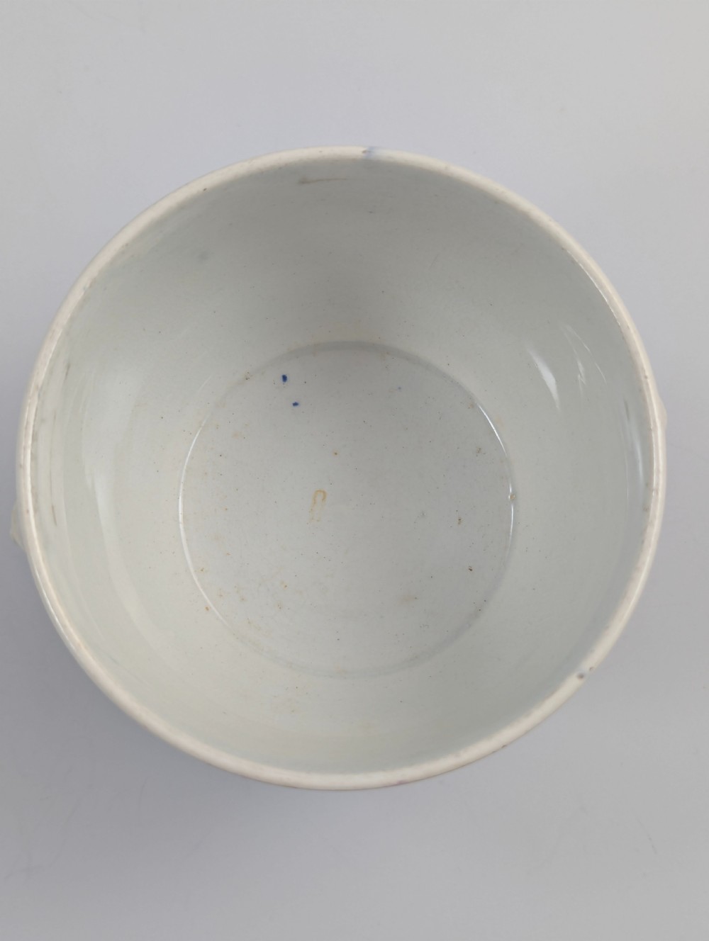 A 19th-century Staffordshire covered earthenware sugar bowl featuring a purple mulberry transferware romantic scene with lion mask handles and a pointed lid. View VII