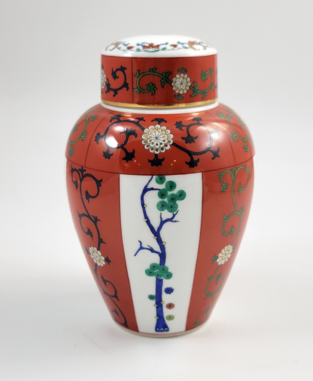 A hand-painted Herend porcelain tea caddy featuring vibrant red Siang Rouge panels, intricate floral vine motifs, and a matching domed lid. View V