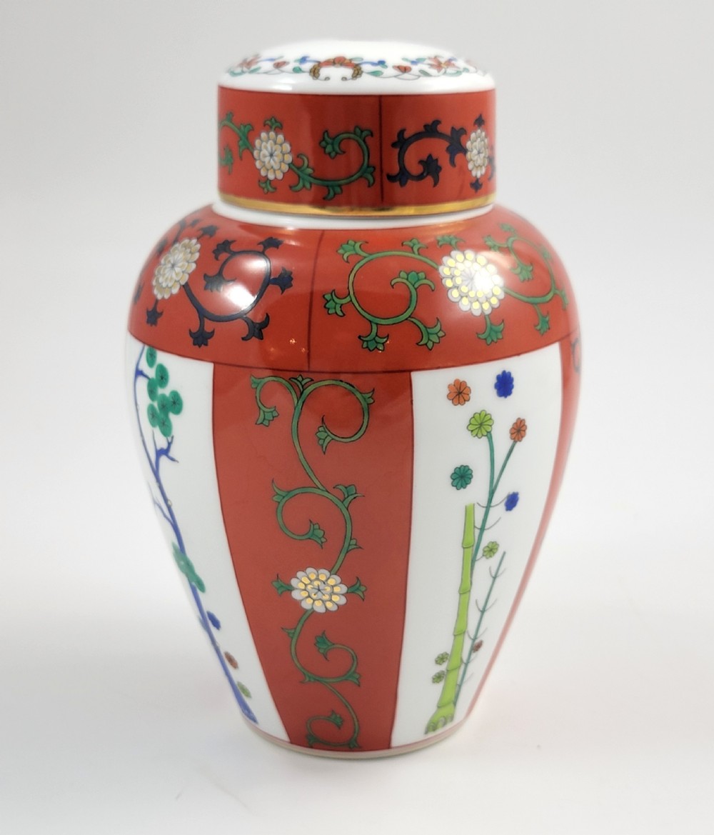 A hand-painted Herend porcelain tea caddy featuring vibrant red Siang Rouge panels, intricate floral vine motifs, and a matching domed lid. View VI