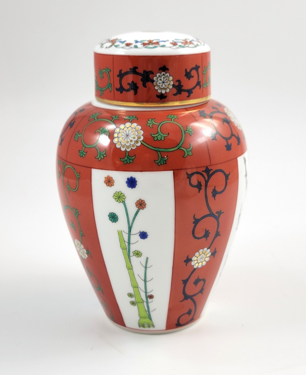 A hand-painted Herend porcelain tea caddy featuring vibrant red Siang Rouge panels, intricate floral vine motifs, and a matching domed lid. View VII