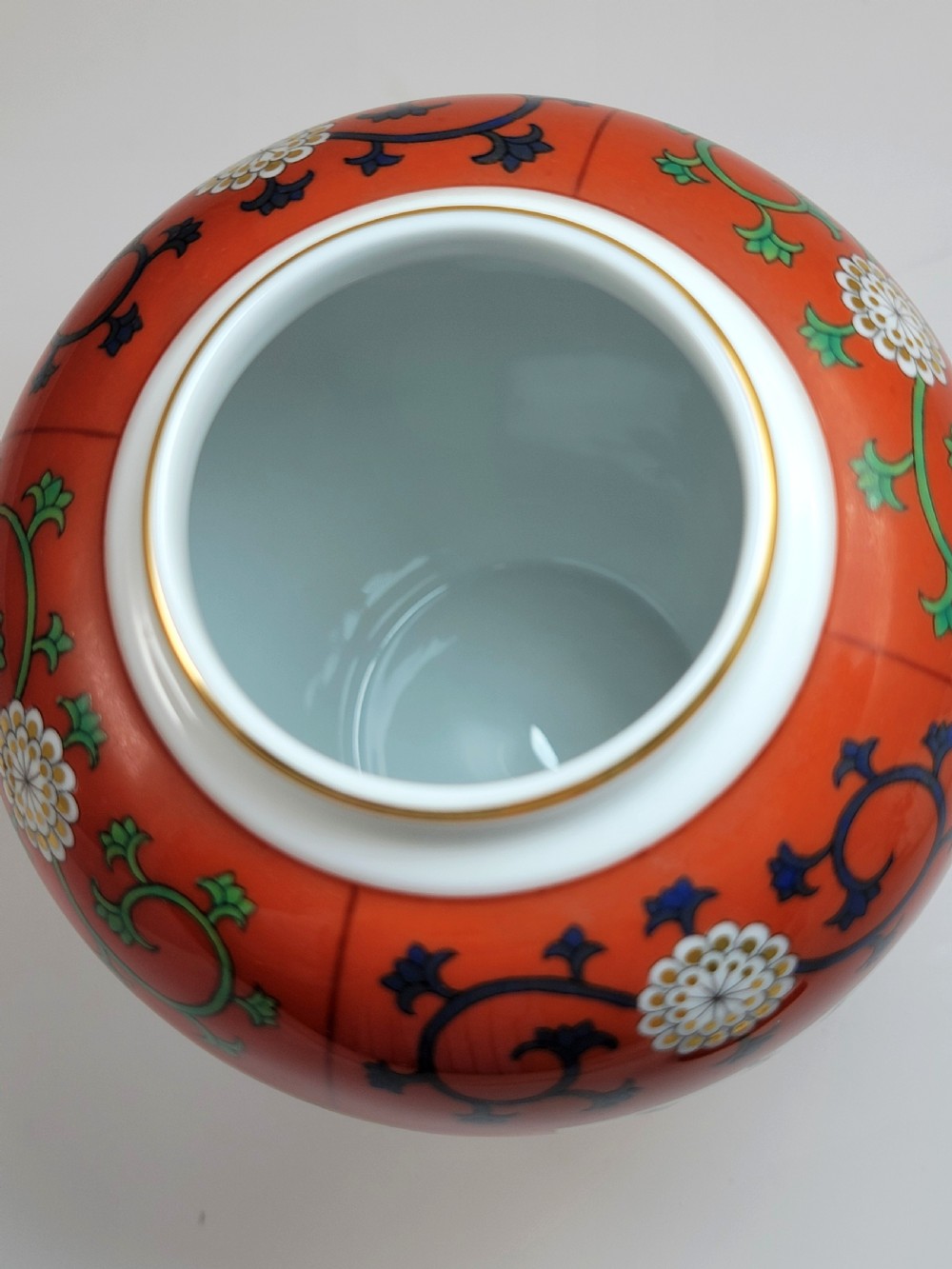 A hand-painted Herend porcelain tea caddy featuring vibrant red Siang Rouge panels, intricate floral vine motifs, and a matching domed lid. View IX