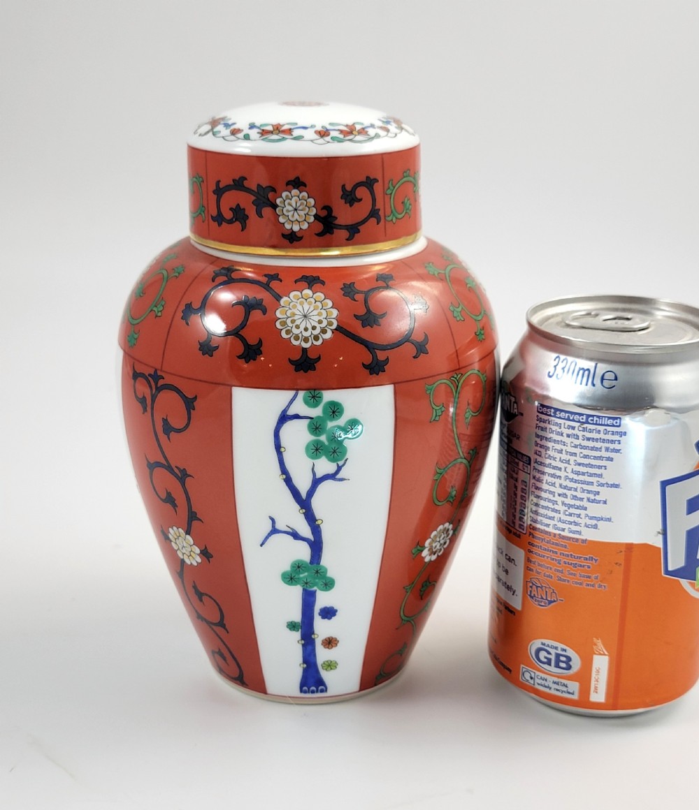 A hand-painted Herend porcelain tea caddy featuring vibrant red Siang Rouge panels, intricate floral vine motifs, and a matching domed lid. View XII