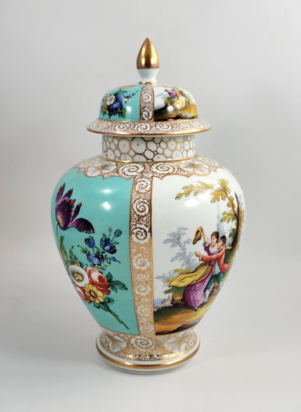 A 19th-century Dresden porcelain lidded vase featuring turquoise ground panels, gilded scrollwork, and hand-painted Watteau pastoral scenes. View IV