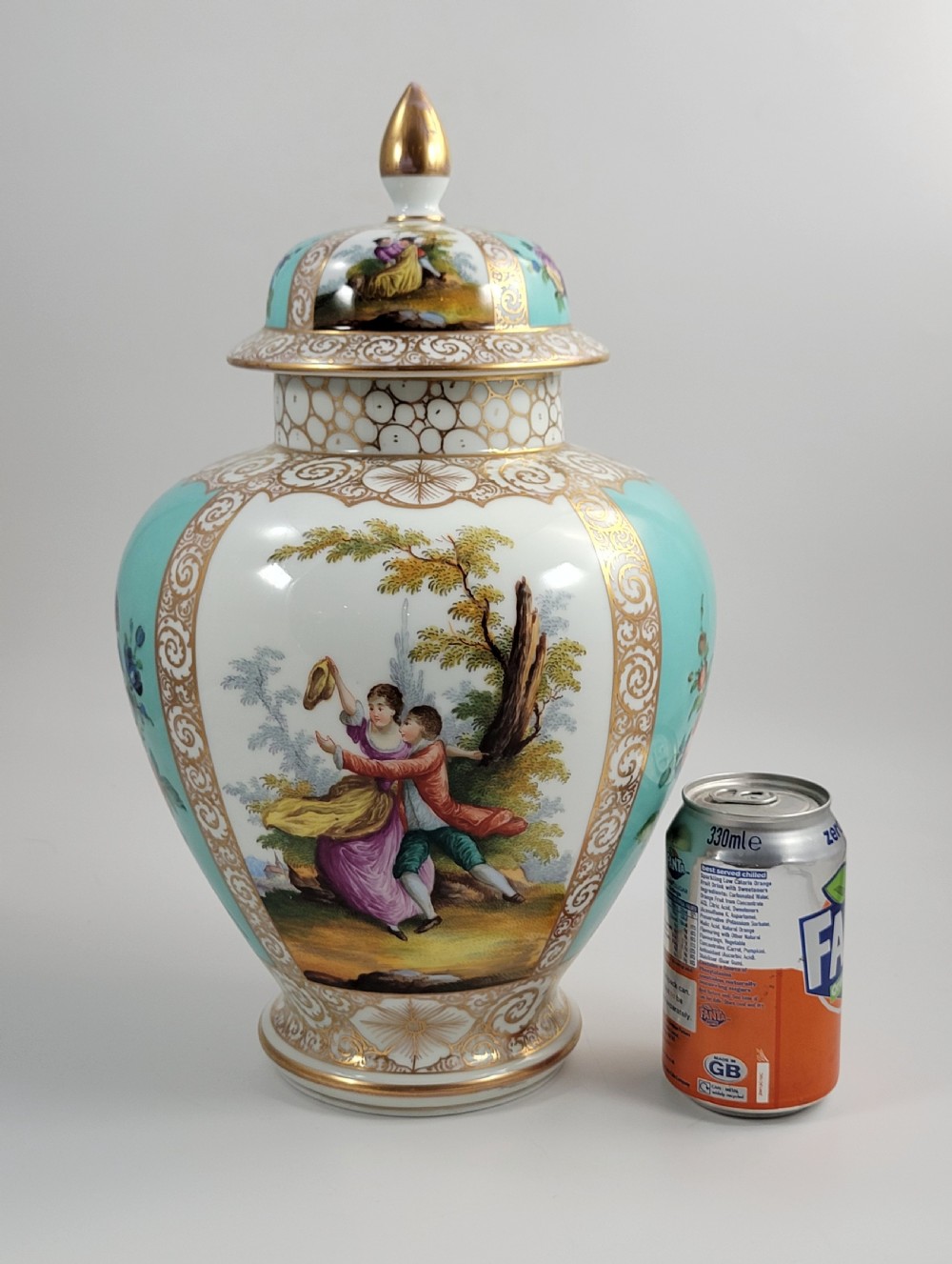 A 19th-century Dresden porcelain lidded vase featuring turquoise ground panels, gilded scrollwork, and hand-painted Watteau pastoral scenes. View XI