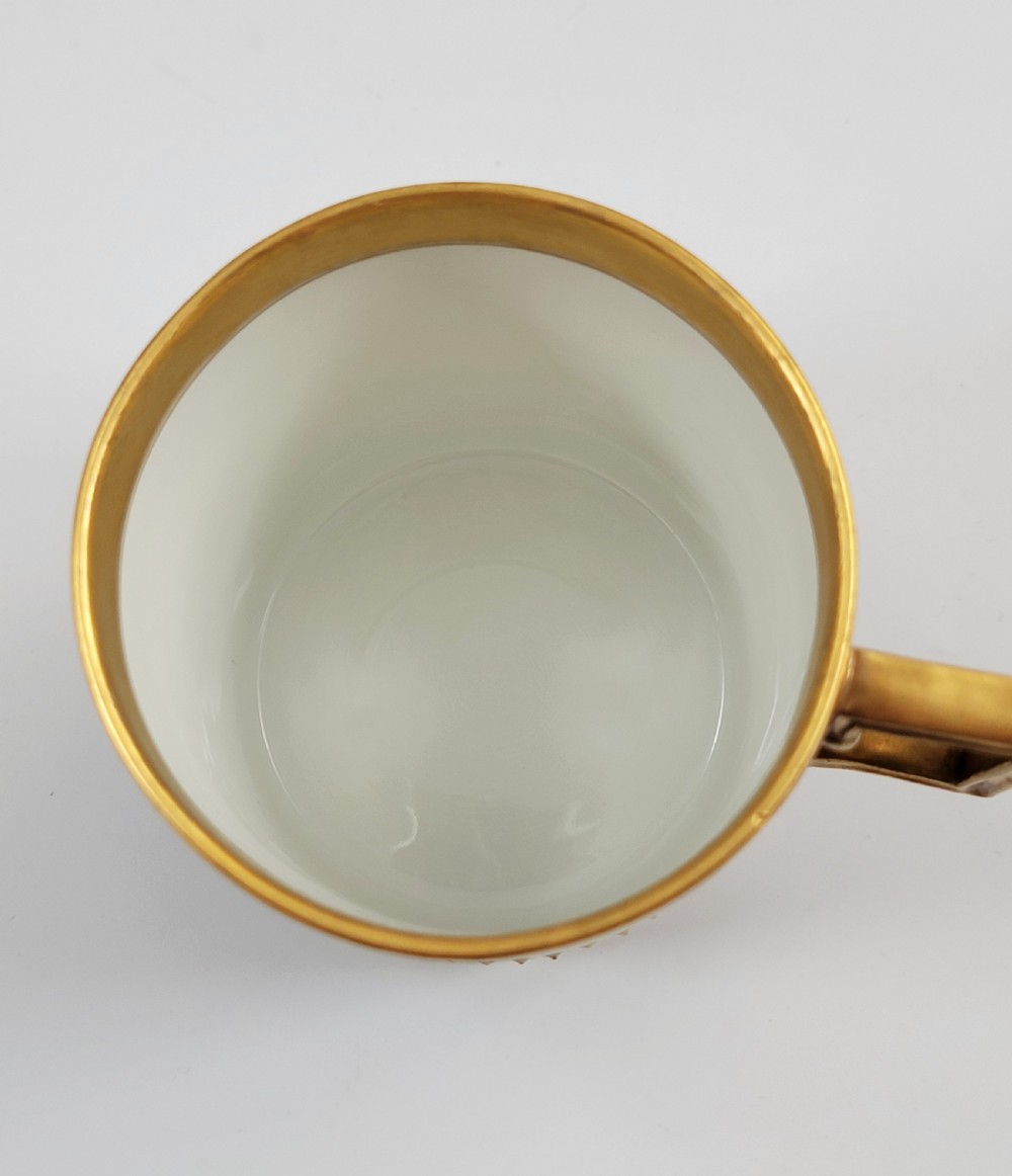 A cobalt blue porcelain covered cup featuring gold leaf scrollwork trim and a hand-painted allegorical woodland vignette with classical figures. View VIII