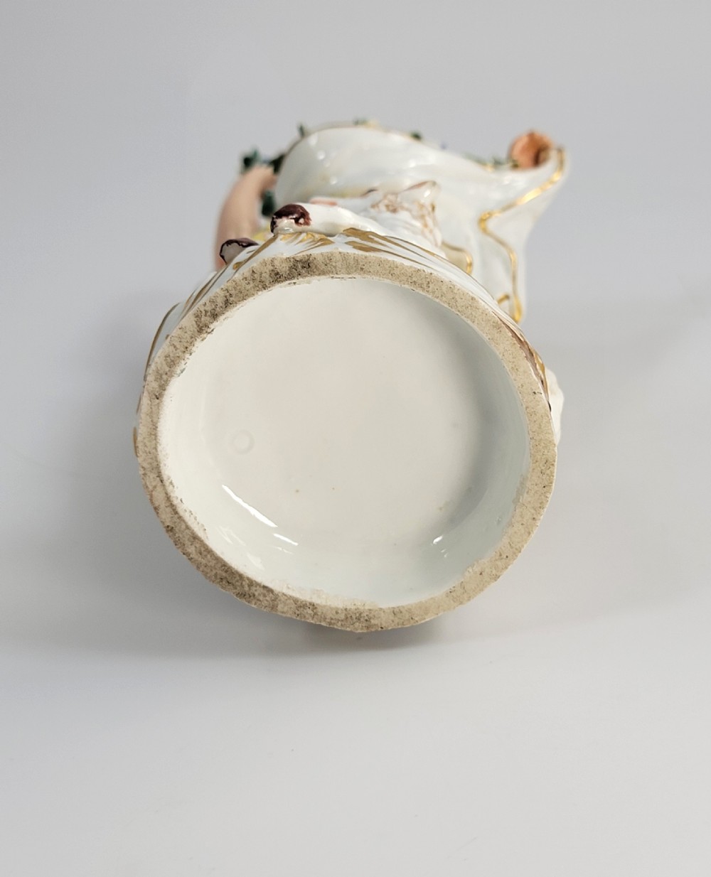A 19th-century German porcelain figure depicting a shepherdess in a yellow patterned skirt with a lamb resting at her feet. View VIII