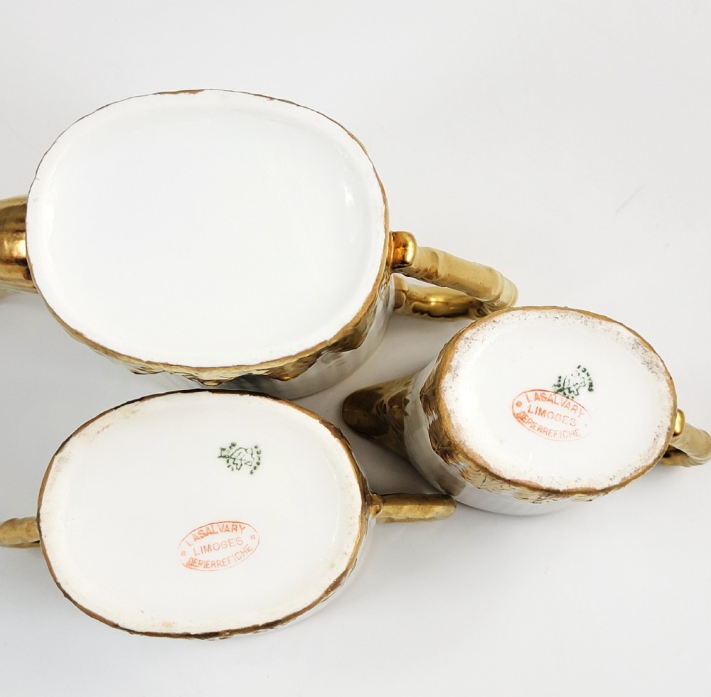 A three-piece white porcelain coffee set featuring a pot, sugar bowl, and cream jug with fluted bodies and gilded acanthus leaf detailing. View VIII